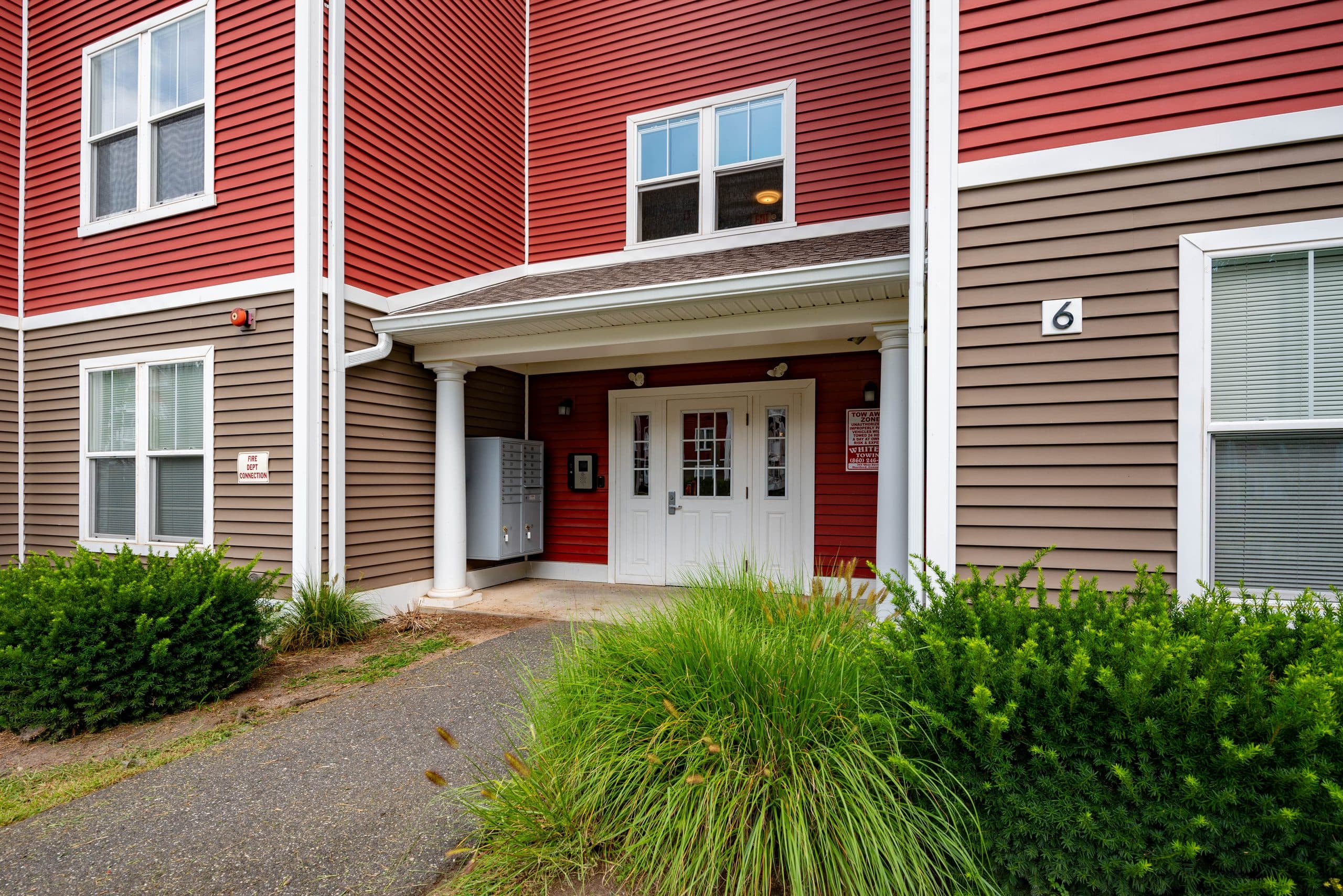 The secured front door of Brook Hill Village building 6, with resident mailboxes under the covered entry